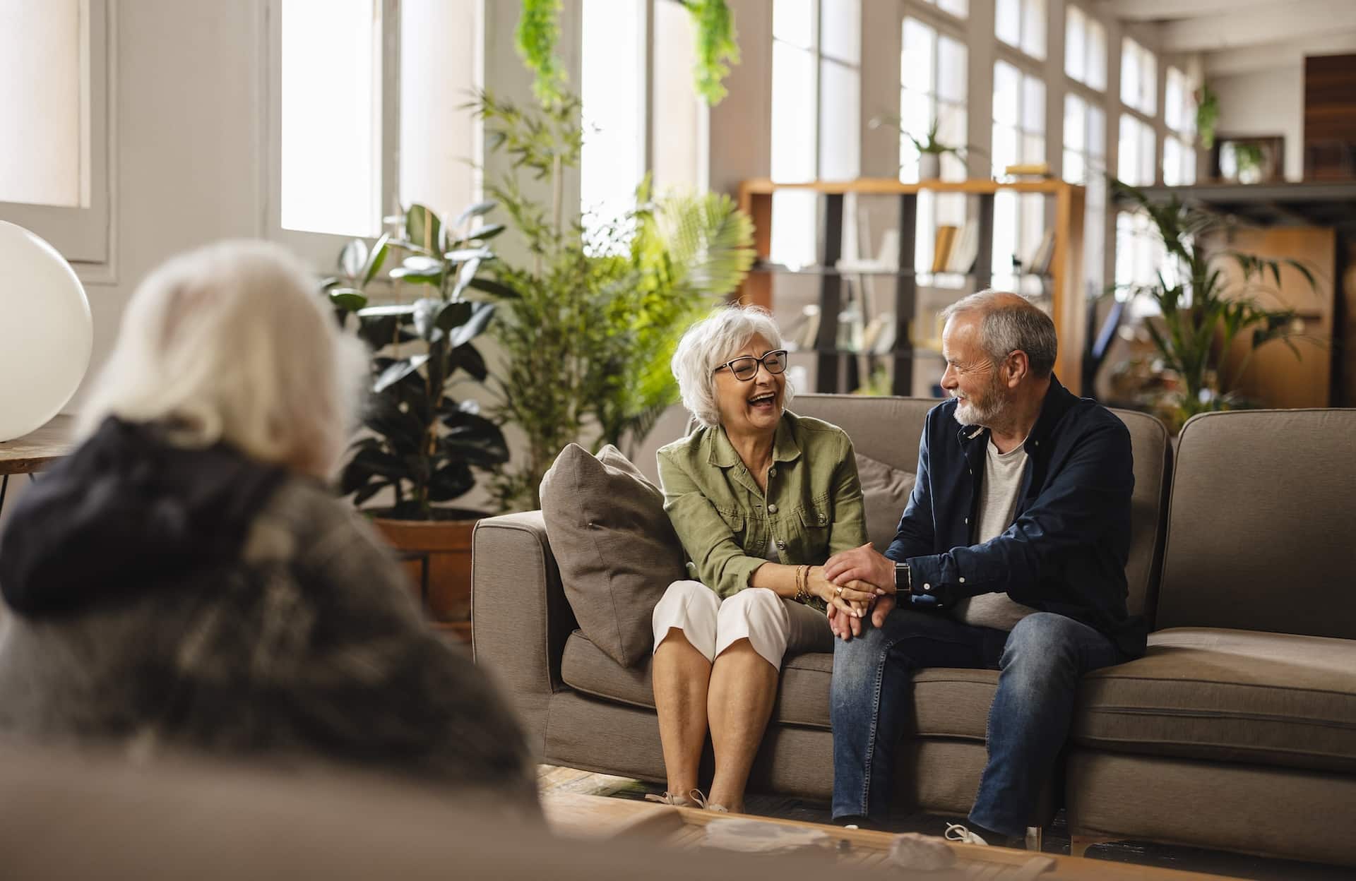 senior friends having fun in the living room at home laughing